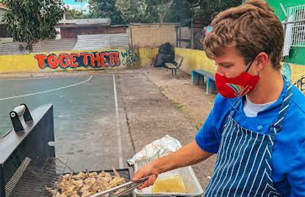 Eye Witness News article feature image of I Can member making food on BBQ